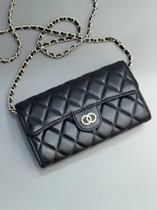 Black quilted leather chain bag detail, elegant diamond pattern and metallic strap.