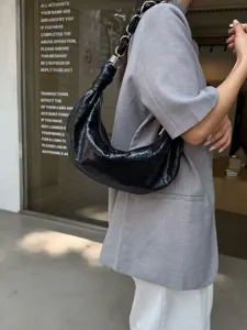 Black leather crescent underarm bag for women, stylish chain strap hobo shoulder bag retro style.