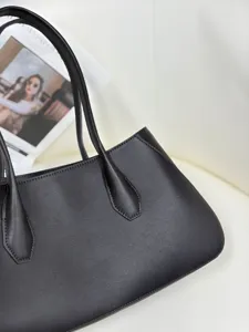 Premium black leather tote bag detail, minimalist design with dual slim handles for chic daily style.
