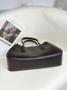 Detailed view of the premium leather underarm tote bag in dark brown, elegant style.