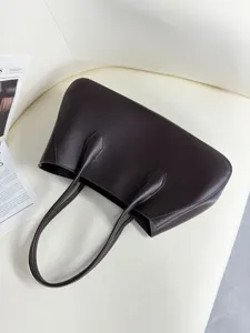 Detail view of dark brown genuine leather tote bag, premium texture and minimalist design.