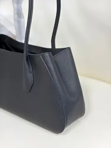 Black top grain leather tote bag for women, classic pebbled texture shoulder bag.