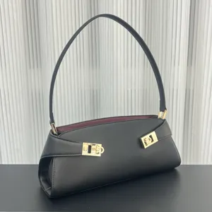 Elegant black leather shoulder bag with gold-tone hardware and stylish contrasting lining.
