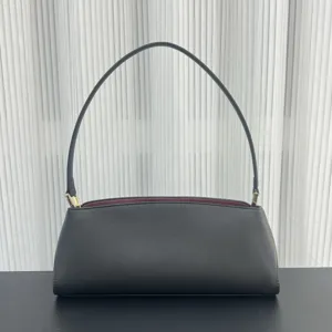 Elegant black leather baguette shoulder bag for women, stylish minimalist underarm handbag.