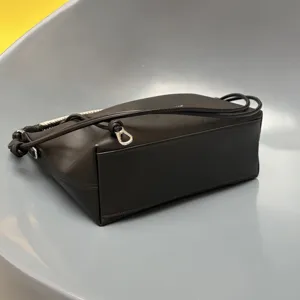 Black leather crossbody bag, woven handle detail, luxury style dumpling handbag for women.