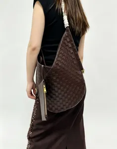 Dark brown woven shoulder bag, soft leather large capacity tote with zipped pouch detail.