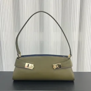 Detail view of the olive green leather shoulder bag with chic gold hardware and sleek strap.