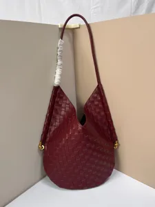 Chic burgundy woven shoulder bag for women, soft leather hobo tote with stylish intrecciato design.