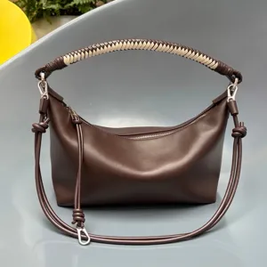 Dark brown leather shoulder bag with braided handle, stylish hobo dumpling handbag.