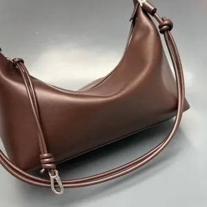 Brown leather crescent shoulder bag with knotted straps stylish minimalist dumpling handbag daily use