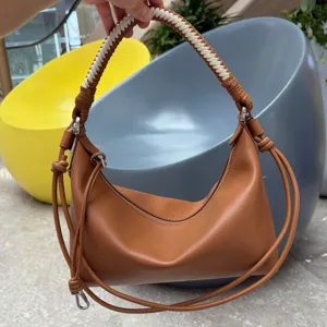 Brown leather hobo shoulder bag with braided handle and stylish dumpling design for daily wear.