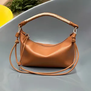 Brown leather shoulder bag with unique hand-woven handle, stylish daily crossbody bag.