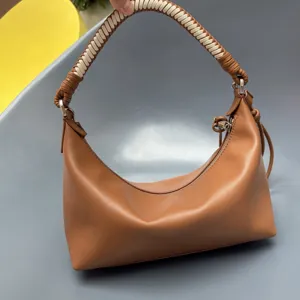 Brown leather shoulder bag with braided handle, stylish hobo dumpling handbag for women daily use.