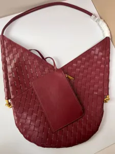 Burgundy woven leather shoulder bag with matching pouch, stylish large capacity hobo tote.