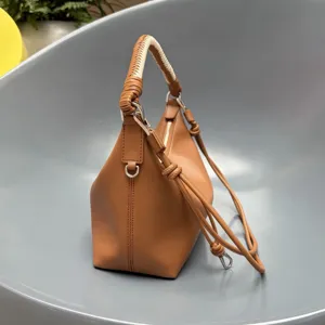 Brown leather shoulder bag with woven handle, stylish dumpling bag for women daily use