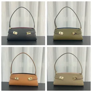 Detailed view of the stylish leather baguette shoulder bag with elegant metal buckles.