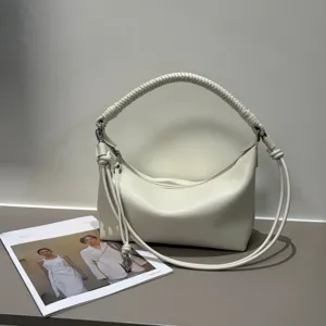 White leather shoulder bag with braided handle and soft pleated design for women stylish daily use.