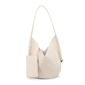 Detailed view of the soft woven leather shoulder tote bag with a matching pouch and handle.