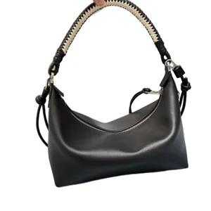 Black leather shoulder bag with stylish woven handle, premium hobo purse for women.