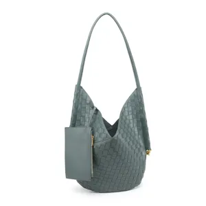 Detailed view of the woven leather texture, soft hobo shoulder bag with attached mini pouch.