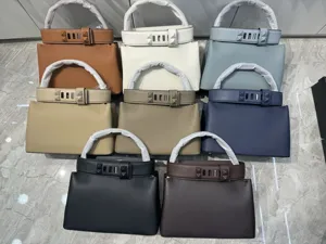 Premium togo leather handbag with iconic pyramid stud belt closure, elegant retro top handle bag.