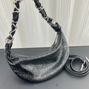 Black textured leather half moon hobo bag detailed view featuring chain strap and metal rings.