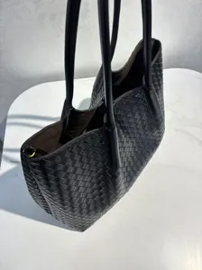 Detailed view of the black genuine leather woven tote bag, showcasing premium craftsmanship.