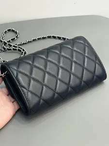 Black quilted lambskin chain shoulder bag, classic luxury style leather crossbody phone bag.