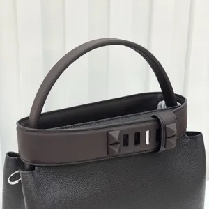 Dark brown leather top handle handbag with pyramid studs retro elegant shoulder bag detail view