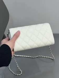 White quilted leather chain crossbody bag, elegant phone pouch with classic diamond pattern.