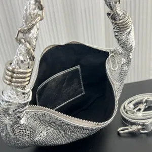 Close-up of the silver metallic hobo dumpling bag with metal ring wrapped handles and zipper.