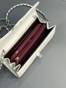 Quilted leather chain phone bag detail view, showcasing interior capacity, premium white finish.