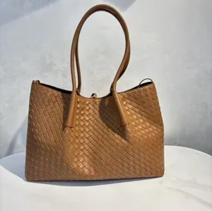 Brown leather woven tote bag detail, premium cowhide shoulder bag fine craftsmanship.