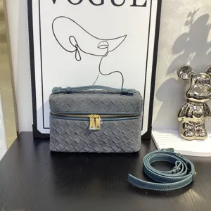 Detailed view of the dark grey woven vanity bag showcasing premium suede texture and hardware.