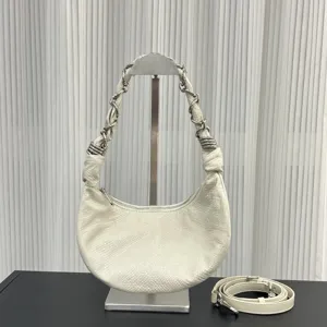 Detailed view of the white leather crescent hobo bag featuring unique chain intertwined strap.