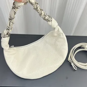 White genuine leather crescent underarm bag with stylish metal chain handle and extra strap.