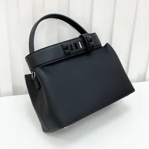 Detailed view of the black leather top handle bag showcasing premium texture and hardware.