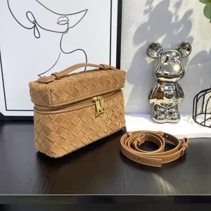Brown suede woven vanity bag with top handle and shoulder strap for daily fashion.