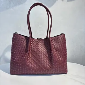 Close-up of premium leather woven tote bag showcasing detailed texture and large capacity.