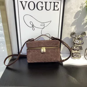 Brown suede woven vanity bag with top handle and adjustable crossbody strap for women.