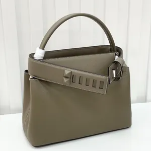 Premium leather retro handbag with top handle and stylish pyramid stud strap for women.