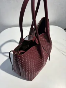 Burgundy genuine leather woven tote bag, large capacity shoulder handbag details.