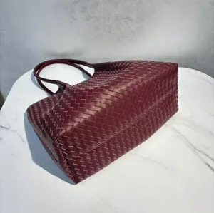 Burgundy leather woven tote bag, large capacity single shoulder handbag detail view.