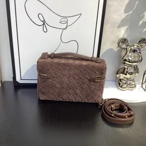 Detailed view of dark brown suede woven box bag showcasing exquisite handcrafted leather texture.