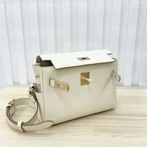 Detail view of premium genuine leather messenger shoulder bag with elegant gold-tone lock hardware.