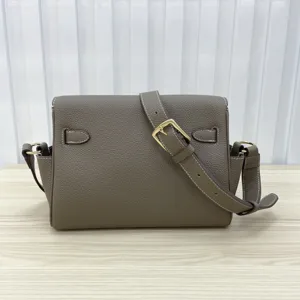 Top-layer cowhide leather messenger bag for women, stylish crossbody bag with metal lock buckle.