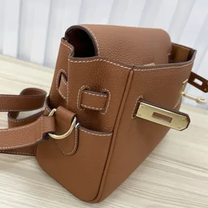 Brown genuine leather Kelly shoulder bag with chic metal lock and top handle for women.