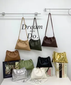 Woven leather shoulder bag detail showing multi-color pouch design and intrecciato craftsmanship.