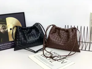Detailed view of woven leather shoulder crossbody bag with drawstring design, casual style.