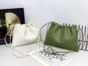 Woven leather drawstring shoulder bag detail view, casual cloud pouch in white and green.